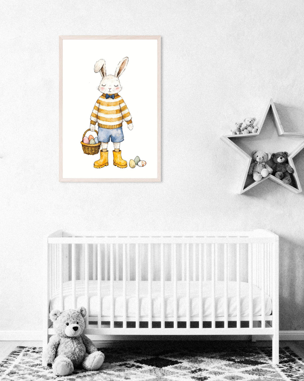 White nursery with a crib, a teddy bear and a framed watercolor poster of a bunny in a striped sweater holding an Easter basket