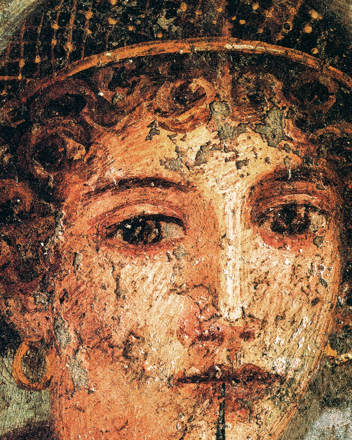 Extreme close-up of Sappho's eyes, curls and gold hairnet on cracked plaster