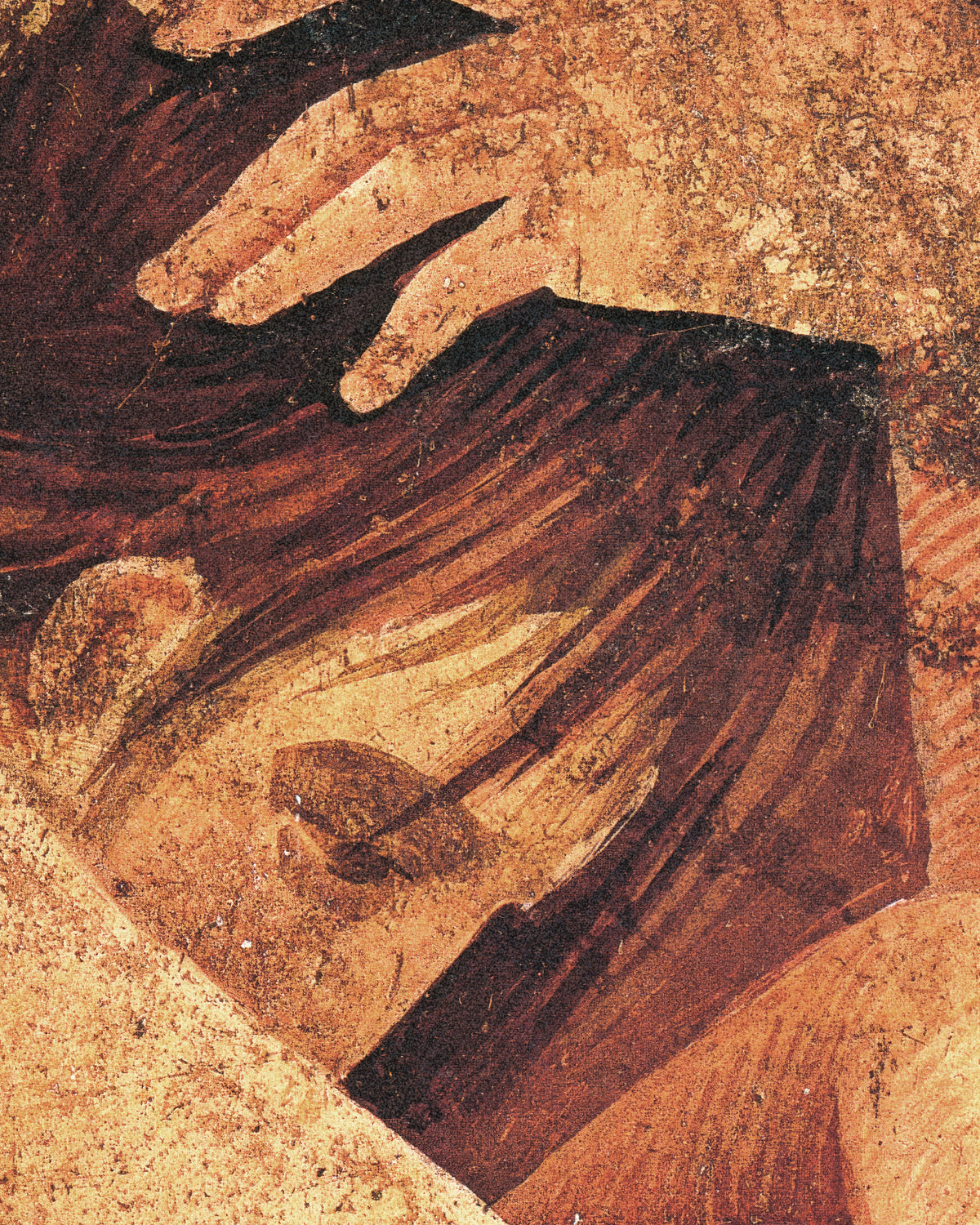 Close-up of a hand resting on the initiate's dark hair