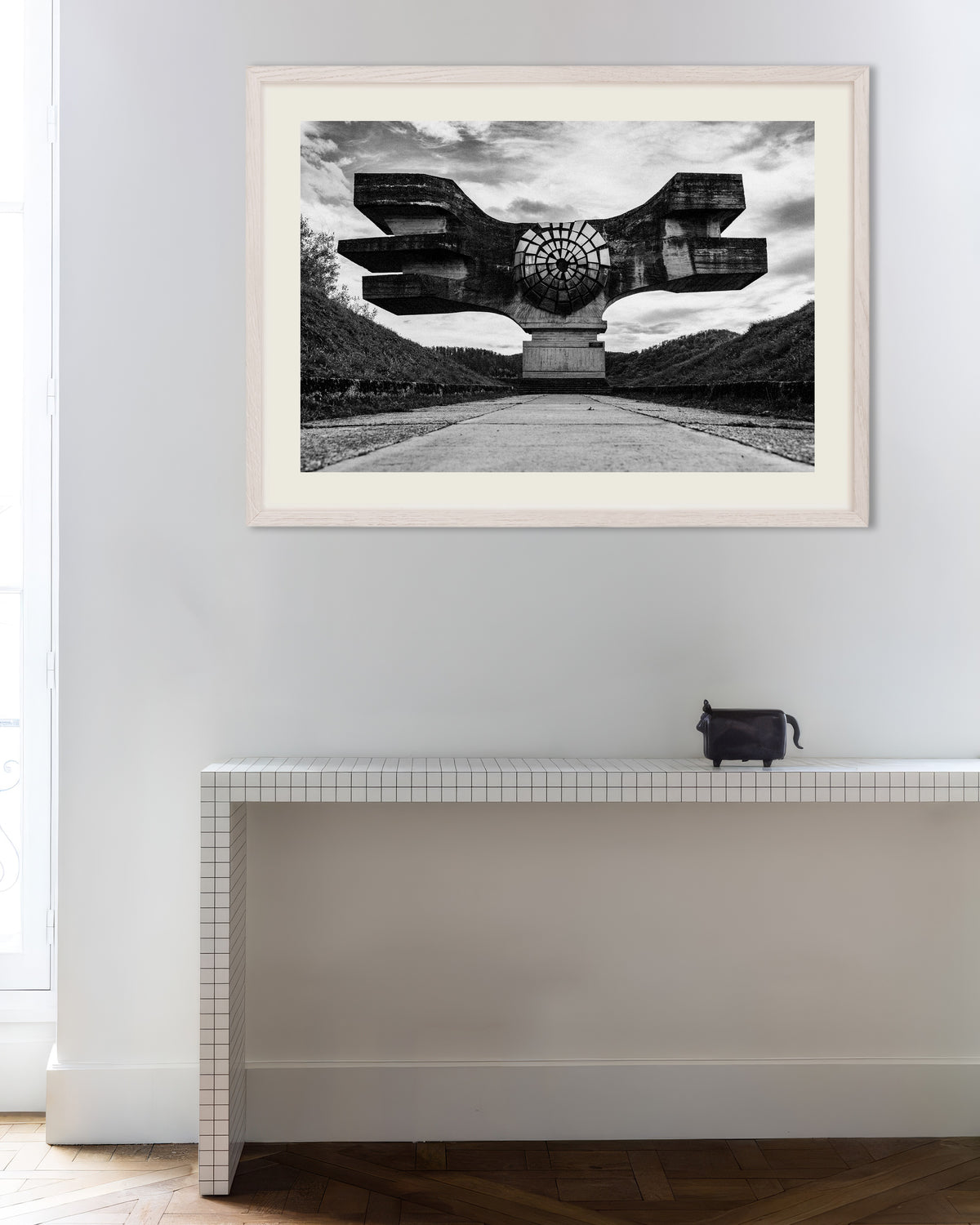 Poster of Winged Monument at the End of the Road, with white wooden frame